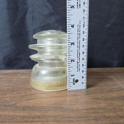 Old glass insulators and three vintage cast iron scale weights