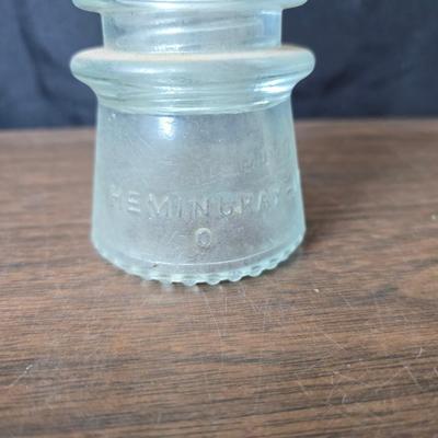 Old glass insulators and three vintage cast iron scale weights