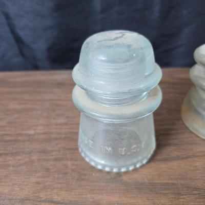 Old glass insulators and three vintage cast iron scale weights