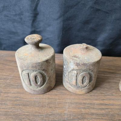 Old glass insulators and three vintage cast iron scale weights