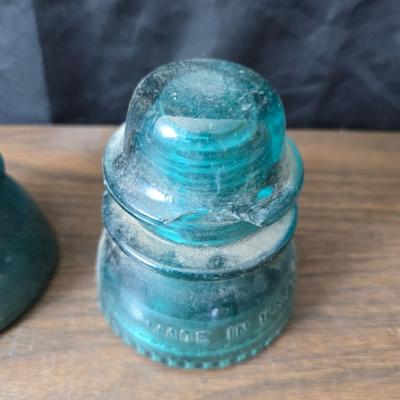 Old glass insulators and three vintage cast iron scale weights