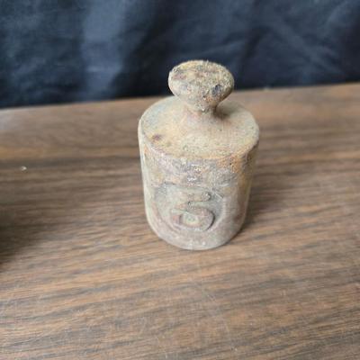 Old glass insulators and three vintage cast iron scale weights
