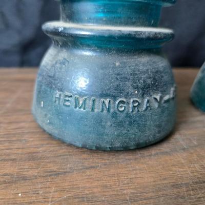 Old glass insulators and three vintage cast iron scale weights