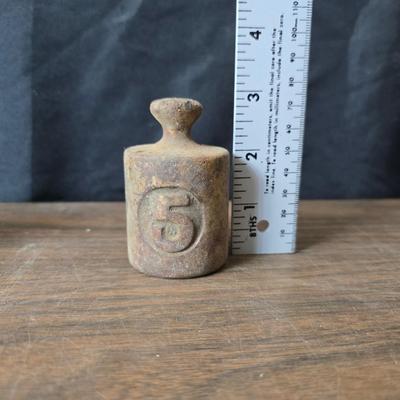 Old glass insulators and three vintage cast iron scale weights