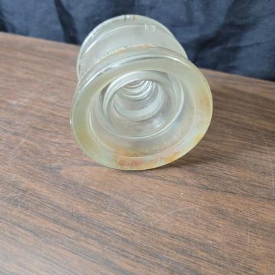 Old glass insulators and three vintage cast iron scale weights