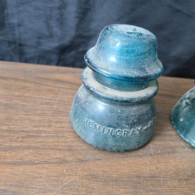 Old glass insulators and three vintage cast iron scale weights