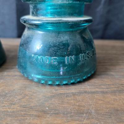 Old glass insulators and three vintage cast iron scale weights