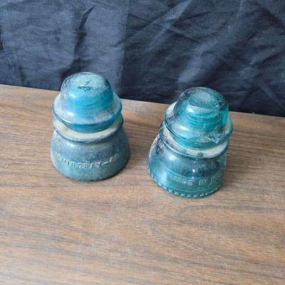 Old glass insulators and three vintage cast iron scale weights