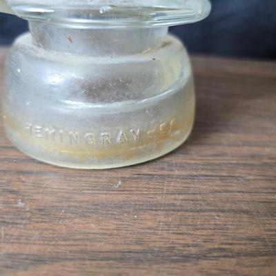 Old glass insulators and three vintage cast iron scale weights