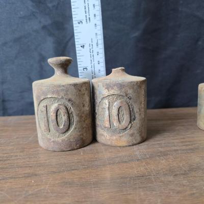 Old glass insulators and three vintage cast iron scale weights