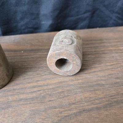 Old glass insulators and three vintage cast iron scale weights