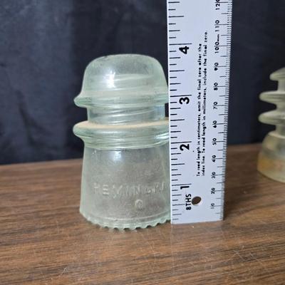 Old glass insulators and three vintage cast iron scale weights