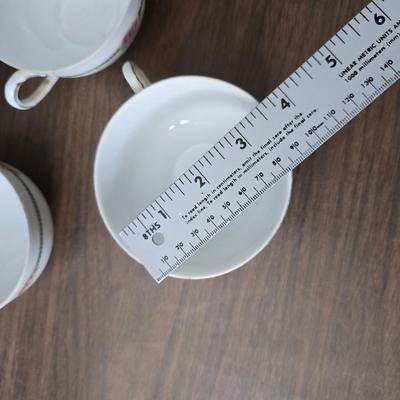 Mid Century French Petitie Choses Brass Candle Holder with a variety of vintage floral China plates