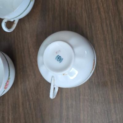 Mid Century French Petitie Choses Brass Candle Holder with a variety of vintage floral China plates