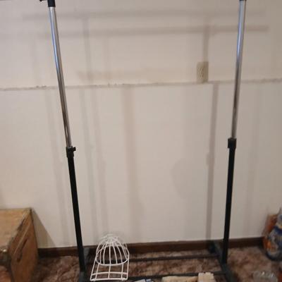 Portable clothes rack with packages of brand-new and opened clothes pins and a baseball cap cleaning tool