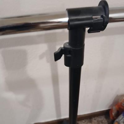 Portable clothes rack with packages of brand-new and opened clothes pins and a baseball cap cleaning tool