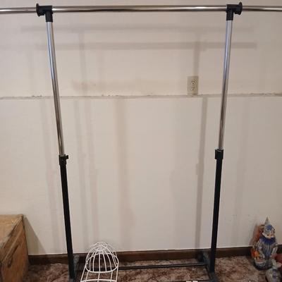 Portable clothes rack with packages of brand-new and opened clothes pins and a baseball cap cleaning tool