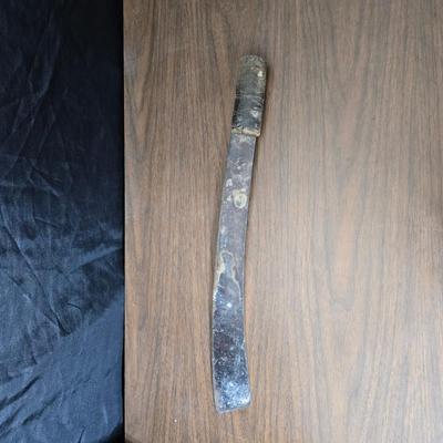 a grouping of U.S. military-issue OG-107 utility uniforms and a old old machete