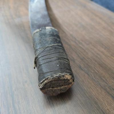 a grouping of U.S. military-issue OG-107 utility uniforms and a old old machete