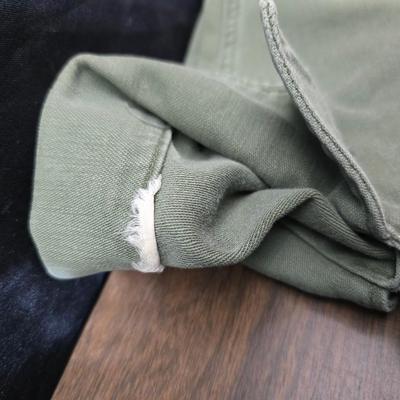 a grouping of U.S. military-issue OG-107 utility uniforms and a old old machete