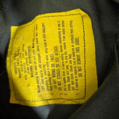 a grouping of U.S. military-issue OG-107 utility uniforms and a old old machete