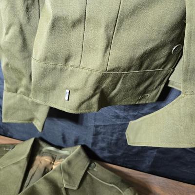 a collection of U.S. Army WWII-era wool Eisenhower, or "Ike", jacket and field shirt