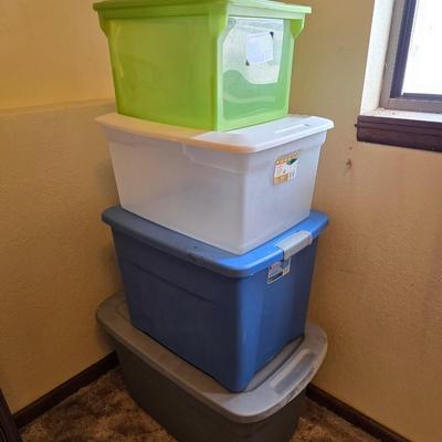 Four storage totes with lids - various sizes