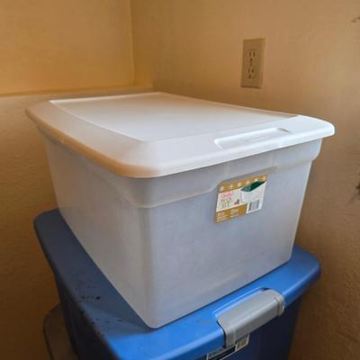 Four storage totes with lids - various sizes