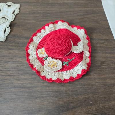 Two framed cross stitch wall art with a collection of pretty doilies