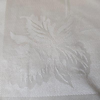 Two framed cross stitch wall art with a collection of pretty doilies