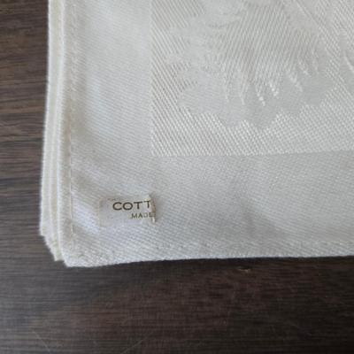 Two framed cross stitch wall art with a collection of pretty doilies