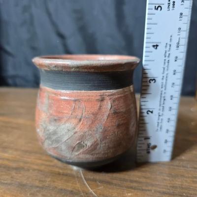Framed artwork with a collection of pottery - and a fossil stone platter