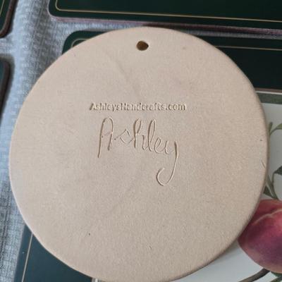 Hooker's Fruits Pimpernel cork backed placemats and matching coasters - Brass candle sticks- a tablecloth and a pottery hotplate