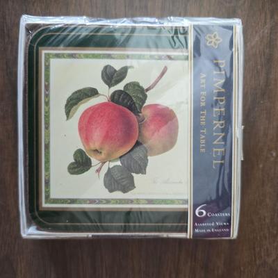 Hooker's Fruits Pimpernel cork backed placemats and matching coasters - Brass candle sticks- a tablecloth and a pottery hotplate