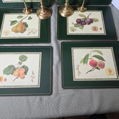 Hooker's Fruits Pimpernel cork backed placemats and matching coasters - Brass candle sticks- a tablecloth and a pottery hotplate