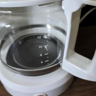 Sunbeam coffee maker with a selection of coffee mugs