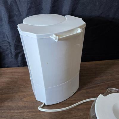 Sunbeam coffee maker with a selection of coffee mugs