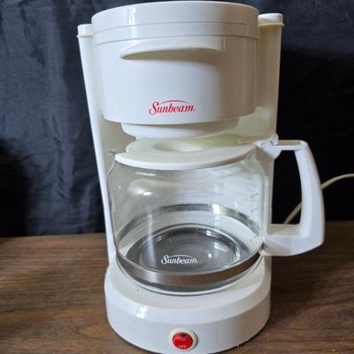 Sunbeam coffee maker with a selection of coffee mugs