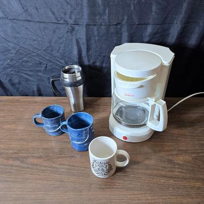 Sunbeam coffee maker with a selection of coffee mugs