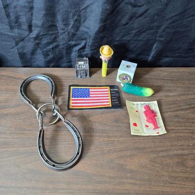 Collection of trinkets and gag gifts -cast Slot machine - iron on flag - Pez pal Pete with no feet -grow a date- horseshoe puzzle - over...