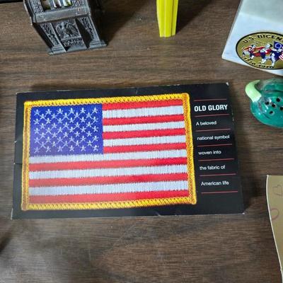 Collection of trinkets and gag gifts -cast Slot machine - iron on flag - Pez pal Pete with no feet -grow a date- horseshoe puzzle - over...