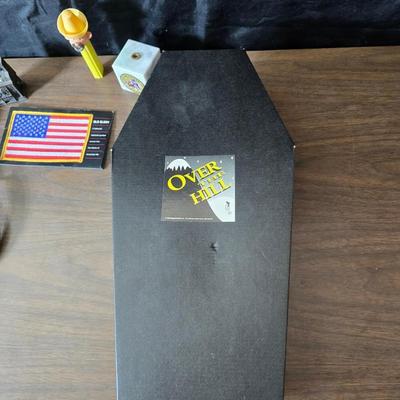 Collection of trinkets and gag gifts -cast Slot machine - iron on flag - Pez pal Pete with no feet -grow a date- horseshoe puzzle - over...