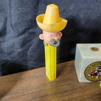 Collection of trinkets and gag gifts -cast Slot machine - iron on flag - Pez pal Pete with no feet -grow a date- horseshoe puzzle - over...