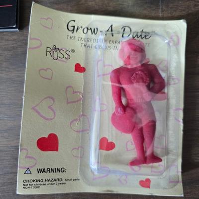 Collection of trinkets and gag gifts -cast Slot machine - iron on flag - Pez pal Pete with no feet -grow a date- horseshoe puzzle - over...