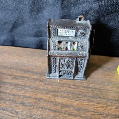 Collection of trinkets and gag gifts -cast Slot machine - iron on flag - Pez pal Pete with no feet -grow a date- horseshoe puzzle - over...