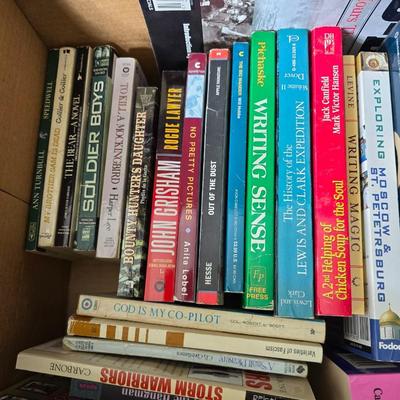 Boxes of softback books of different genres - Anne Frank - and more