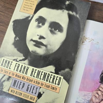 Boxes of softback books of different genres - Anne Frank - and more