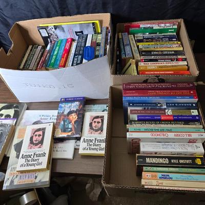 Boxes of softback books of different genres - Anne Frank - and more
