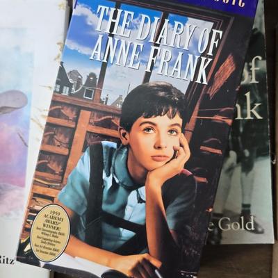 Boxes of softback books of different genres - Anne Frank - and more