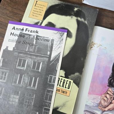 Boxes of softback books of different genres - Anne Frank - and more